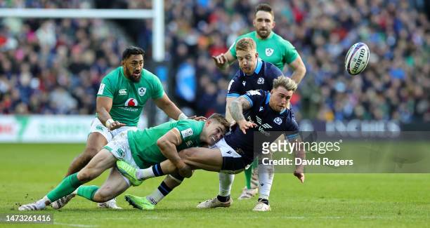 Stuart Hogg of Scotland off loads the ball as Garry Ringrose tackles during the Six Nations Rugby match between Scotland and Ireland at Murrayfield...