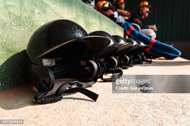 a row of baseball helmets in a dugout - dugout 個照片及圖片檔