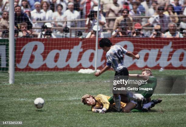 Argentina captain Diego Maradona collides with West Germany goalkeeper Harald Schumacher and KarlHienz Forster in the penalty area during the FIFA...