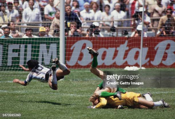 Argentina captain Diego Maradona collides with West Germany goalkeeper Harald Schumacher and KarlHienz Forster in the penalty area during the FIFA...