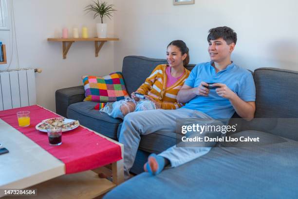happy smiling couple having fun at home playing video games - casa calvet stock pictures, royalty-free photos & images