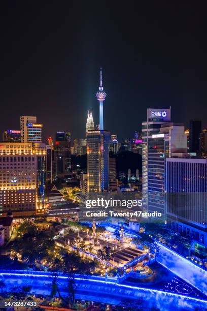 aerial view of illuminated masjid jamek and skyscrapers at night in kuala lumpur - moské bildbanksfoton och bilder