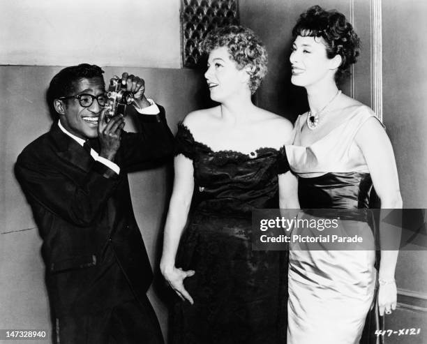 American actor and singer Sammy Davis, Jr photographs actresses Shelley Winters and Rita Gam at the Waldorf-Astoria Hotel, New York City, 18th...