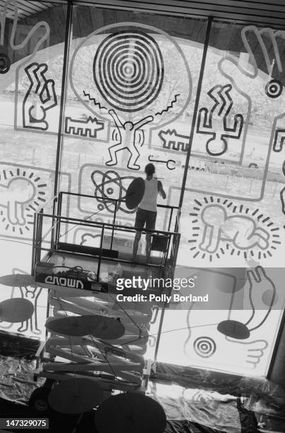 American artist Keith Haring working on a mural at the National Gallery of Victoria in Melbourne, Australia, 1984. Haring's mural temporarily...