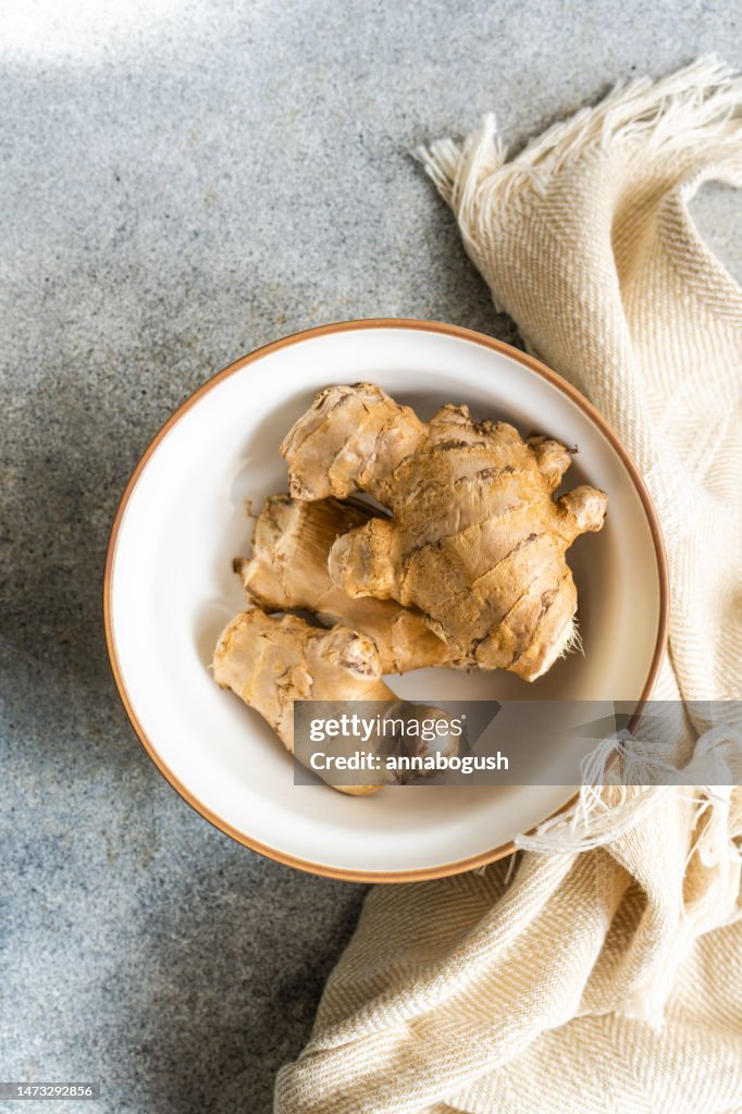 Overhead view of a bowl with a fresh ginger root