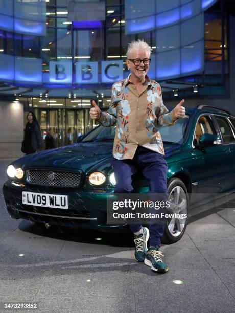 Radio DJ Chris Evans poses with a Jaguar formerly owned by Queen Elizabeth II before appearing on "The One Show" at BBC Broadcasting House on March...