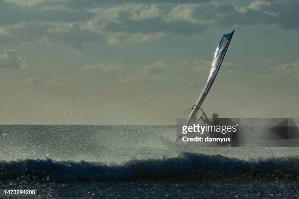 silhouette of a windsurfer in ocean, sanxenxo, pontevedra, galicia, spain - windsurf stockfoto's en -beelden