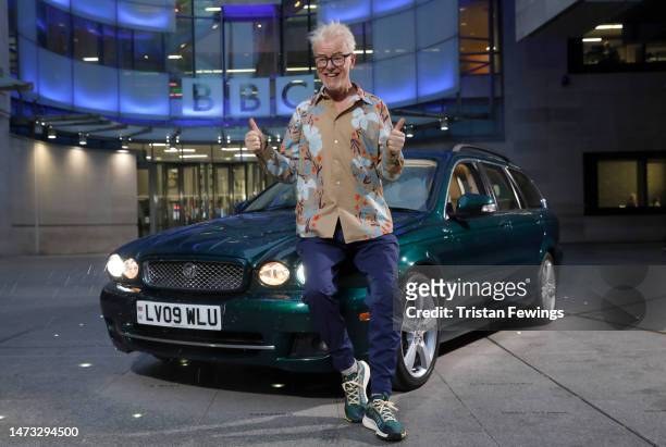 Radio DJ Chris Evans poses with a Jaguar formerly owned by Queen Elizabeth II before appearing on "The One Show" at BBC Broadcasting House on March...