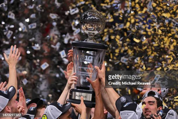The Purdue Boilermakers raise the trophy after defeating the Penn State Nittany Lions in the Big Ten Basketball Tournament Championship game at...