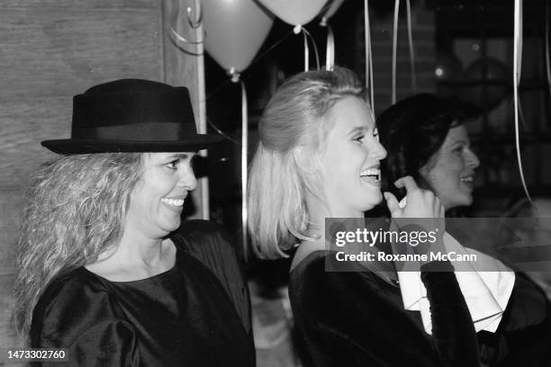 Award-winning actress Nicollette Sheridan, right, listens to the speaker at her surprise thirtieth birthday party next to her mother, left, actress...
