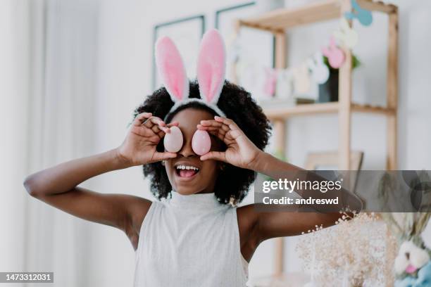 child playing with easter eggs on face - easter sunday stock pictures, royalty-free photos & images