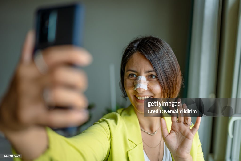 Business woman having online meeting after nose surgery