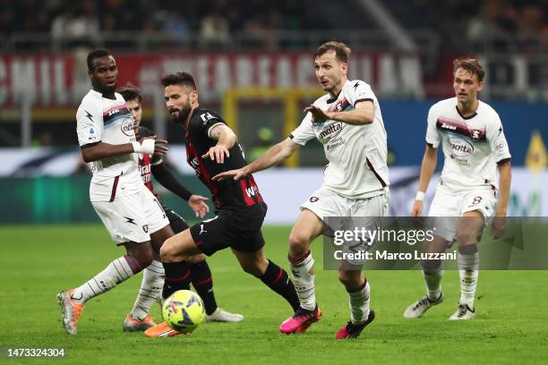 Olivier Giroud of AC Milan and Norbert Gyomber of Salernitana battle for the ball during the Serie A match between AC Milan and Salernitana at Stadio...