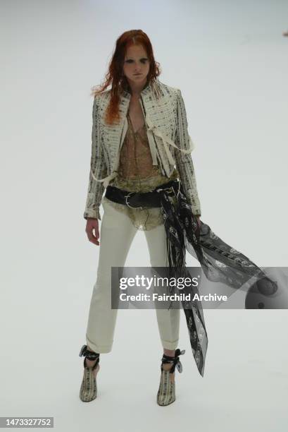 Model walks the runway at the Spring 2003 Alexander McQueen show in Paris.