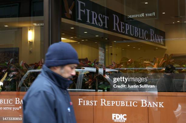 Person walks by the First Republic Bank headquarters on March 13, 2023 in San Francisco, California. First Republic shares lost over 60 percent on...