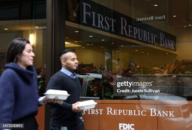 People walk by the First Republic Bank headquarters on March 13, 2023 in San Francisco, California. First Republic shares lost over 60 percent on...