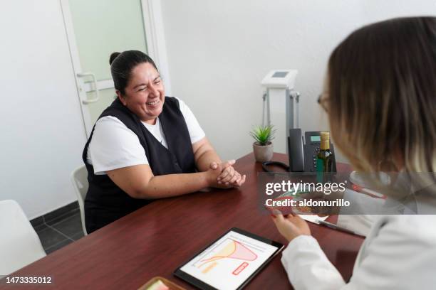 happy overweight woman listening to nutritionist - body mass index stock pictures, royalty-free photos & images