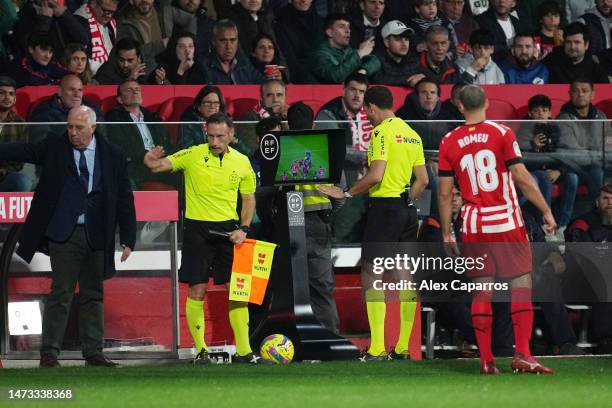 Match Referee, Melero Lopez checks the VAR screen during the LaLiga Santander match between Girona FC and Atletico de Madrid at Montilivi Stadium on...