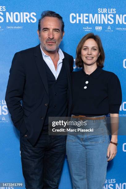 Jean Dujardin and Nathalie Pechalat attend the ""Sur Les Chemins Noirs" premiere at Cinema UGC Normandie on March 13, 2023 in Paris, France.