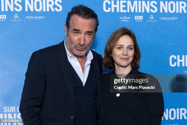 Jean Dujardin and Nathalie Pechalat attend the ""Sur Les Chemins Noirs" premiere at Cinema UGC Normandie on March 13, 2023 in Paris, France.