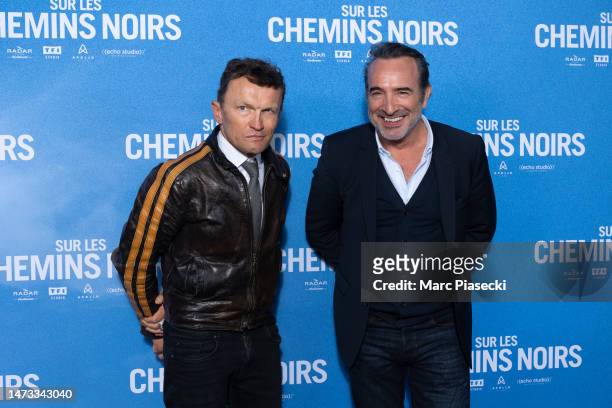 Sylvain Tesson and Jean Dujardin attend the ""Sur Les Chemins Noirs" premiere at Cinema UGC Normandie on March 13, 2023 in Paris, France.