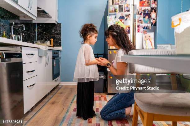 little girl being spoken to sternly at home by her mother - punishment stock pictures, royalty-free photos & images