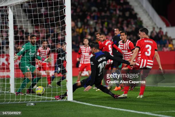 Alvaro Morata of Atletico Madrid scores the team's first goal during the LaLiga Santander match between Girona FC and Atletico de Madrid at Montilivi...