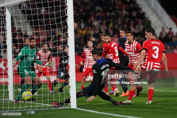 Alvaro Morata of Atletico Madrid scores the team's first goal during the LaLiga Santander match between Girona FC and Atletico de Madrid at Montilivi...