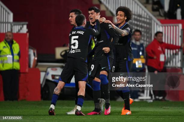 Alvaro Morata of Atletico Madrid celebrates with teammates after scoring the team's first goal during the LaLiga Santander match between Girona FC...
