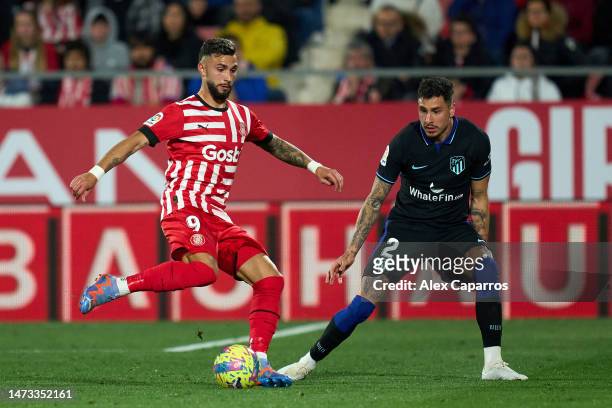Valentin ‘Taty’ Castellanos of Girona FC is challenged by Jose Maria Gimenez of Atletico de Madrid during the LaLiga Santander match between Girona...