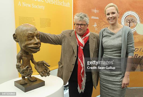 Hans Georg Naeder, head of the Otto Bock Group and former First Lady Bettina Wulff pose after speaking to the media about German musician Peter...