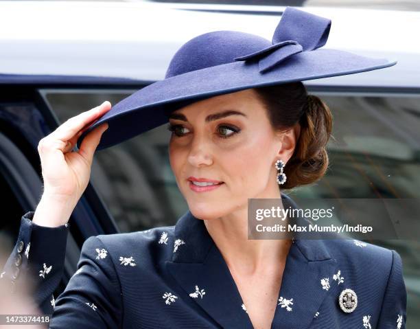 Catherine, Princess of Wales holds onto her hat in the wind as she attends the 2023 Commonwealth Day Service at Westminster Abbey on March 13, 2023...