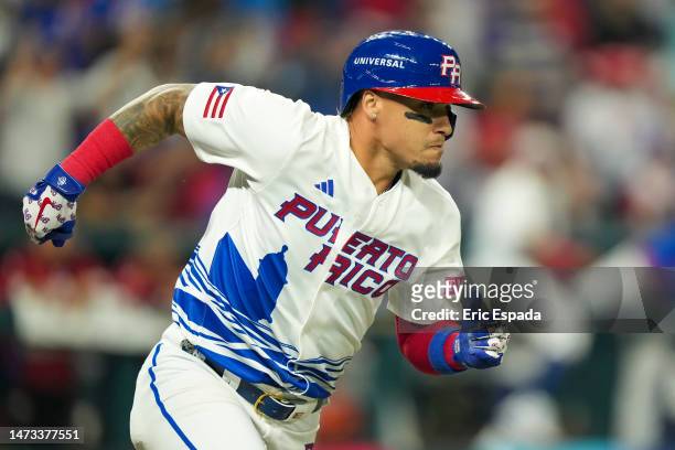 Javy Baez of Puerto Rico runs towards first base after hitting a double during the first inning against Israel at loanDepot park on March 13, 2023 in...