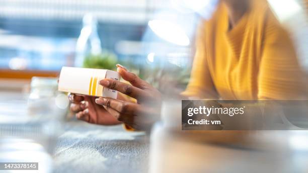 female hands holding medications and reading instruction - ointment stock pictures, royalty-free photos & images