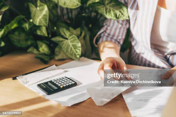 top view close up woman calculating bills, money, loan or rent payments, using laptop, online banking service, sitting at table, female holding receipt, planning budget, managing expenses, finances - extrato-bancário imagens e fotografias de stock