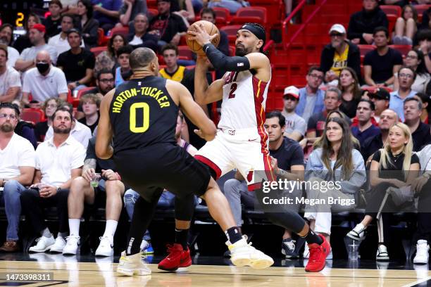 Gabe Vincent of the Miami Heat drives against Talen Horton-Tucker of the Utah Jazz during the second quarter of the game at Miami-Dade Arena on March...