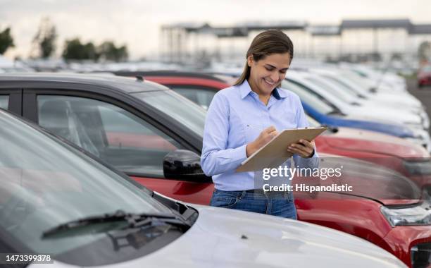 feliz vendedora trabajo en un concesionario de coches - autos usados fotografías e imágenes de stock