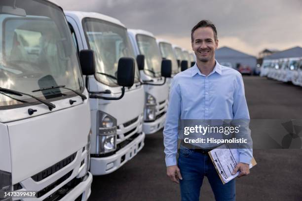 car salesperson selling trucks at a car dealership - trucks in a row stock pictures, royalty-free photos & images