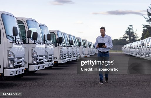 Car salesperson selling trucks at a car dealership Car salesperson selling trucks at a car dealership