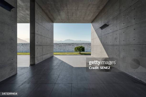 opening in concrete wall with sunlight background - breaking through wall stockfoto's en -beelden