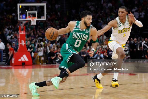 Jayson Tatum of the Boston Celtics drives to the net ahead of Jabari Smith Jr. #1 of the Houston Rockets during the second half at Toyota Center on...