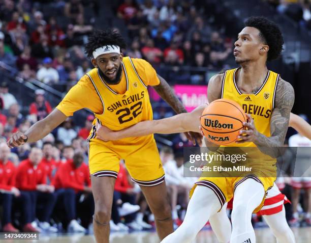 Desmond Cambridge Jr. #4 of the Arizona State Sun Devils shoots against the Arizona Wildcats as Warren Washington of the Sun Devils looks on in the...