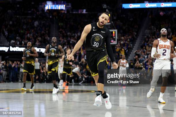 Stephen Curry of the Golden State Warriors reacts after making a three-point basket in the second half against the Phoenix Suns at Chase Center on...