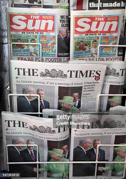 Copies of News Corp.'s newspaper titles, The Sun and The Times, are seen for sale on a newsagent's stand in London, U.K., on Thursday, June 28, 2012....
