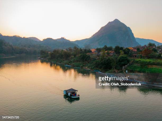 aerial view of boat on mekong river at sunset - asia village river stock pictures, royalty-free photos & images