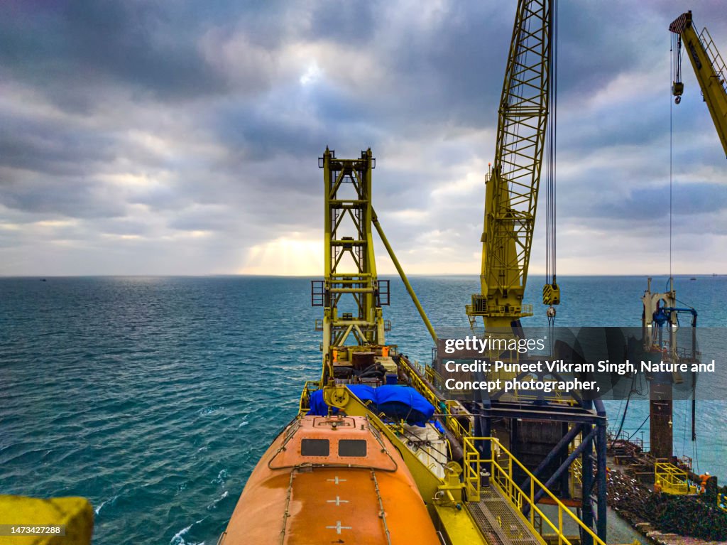 Offshore Construction cranes in the backdrop of sunset