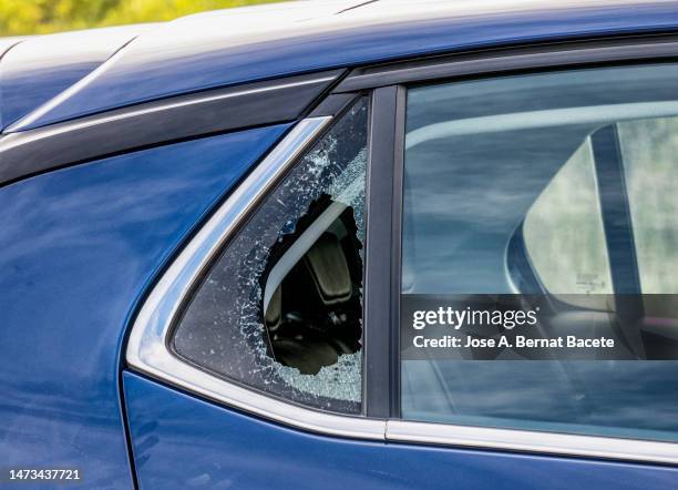 car window with glass broken by a traffic accident. - car crime stock pictures, royalty-free photos & images