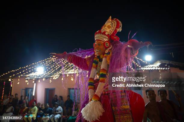Man dressed in the likeness of the Hindu deity Bhagavathy performs during the Theyyam ritualistic dance festival on March 13, 2023 in Somwarpet,...