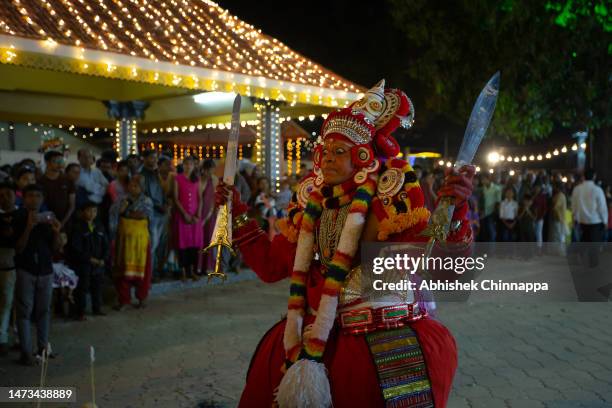 Man dressed in the likeness of the Hindu deity Bhagavathy performs during the Theyyam ritualistic dance festival on March 13, 2023 in Somwarpet,...