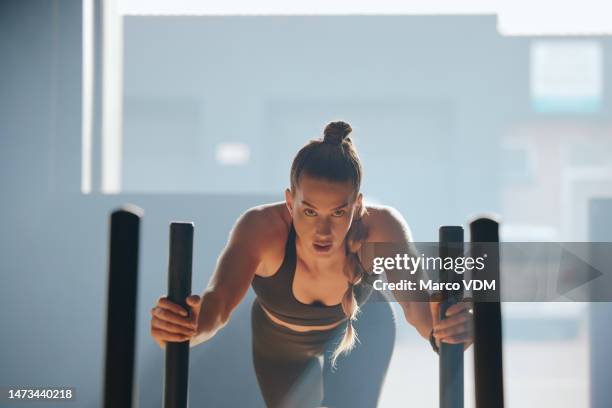 fitness, sled and portrait of a woman in the gym doing strength, endurance and running workout. motivation, sports and female athlete doing intense cardio exercise for building muscle in sport center - sled push stock pictures, royalty-free photos & images